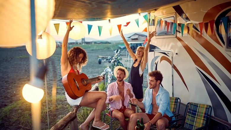 Campers partying with a guitar