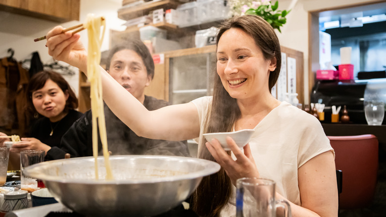 People eating noodles at a Japanese restaurant