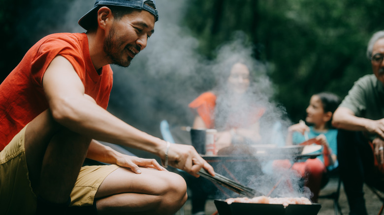 man cooking over fire