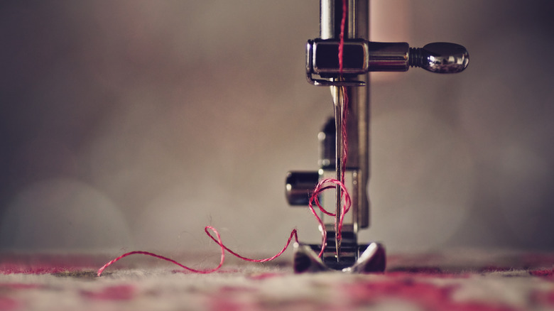 Close-up of sewing machine adding thread to clothing