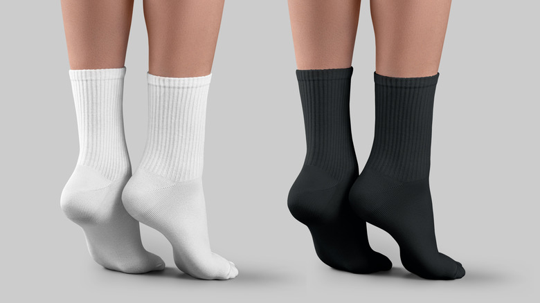 Two pairs of feet wearing cotton socks