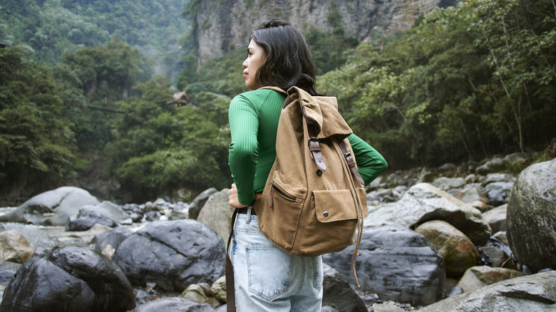 Woman hiking in jeans in rainforest