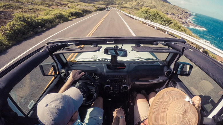 Couple driving convertible SUV