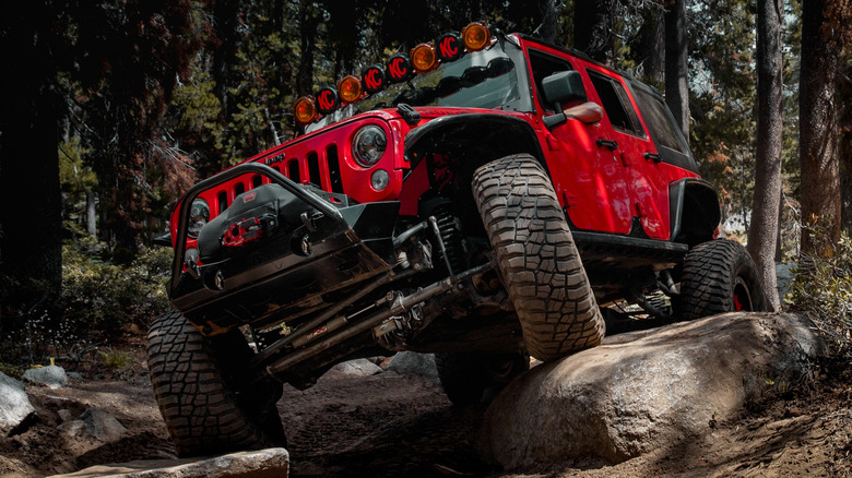 Modified 4x4 Jeep doing a trail crawl