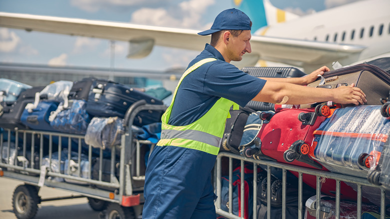 baggage handler with suitcases