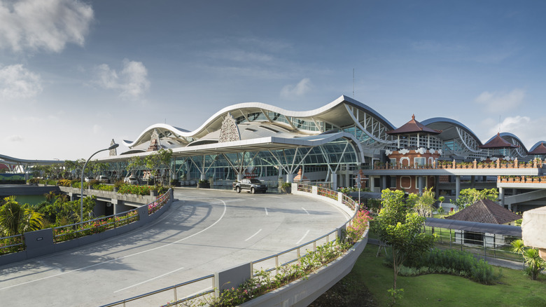 Exterior of Bali Airport with wavy, layered roof and traditional Balinese architecture