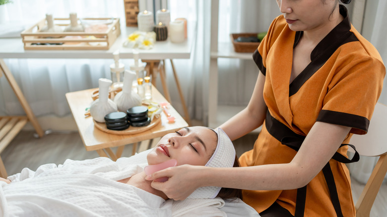 Woman lying down getting a facial treatment