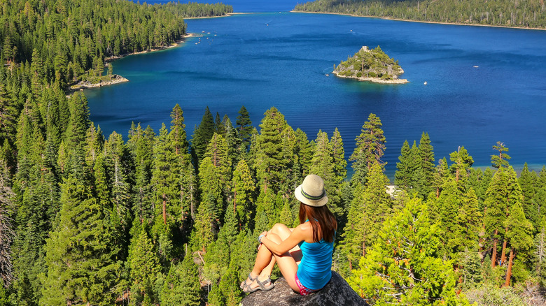 Woman sitting on rock at Emerald Bay