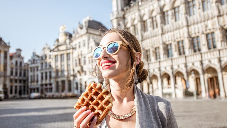woman eating waffle in Brussels