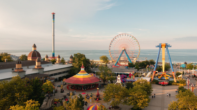 Amusement park with water in the background