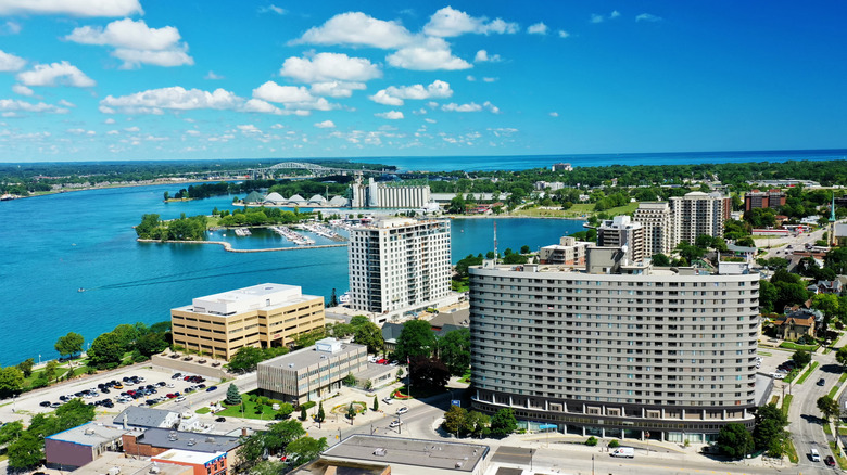 Aeria view of Sarnia, buildings and a parking lot can be seen and some waterfront