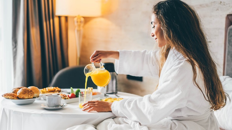 Woman eating breakfast in hotel room