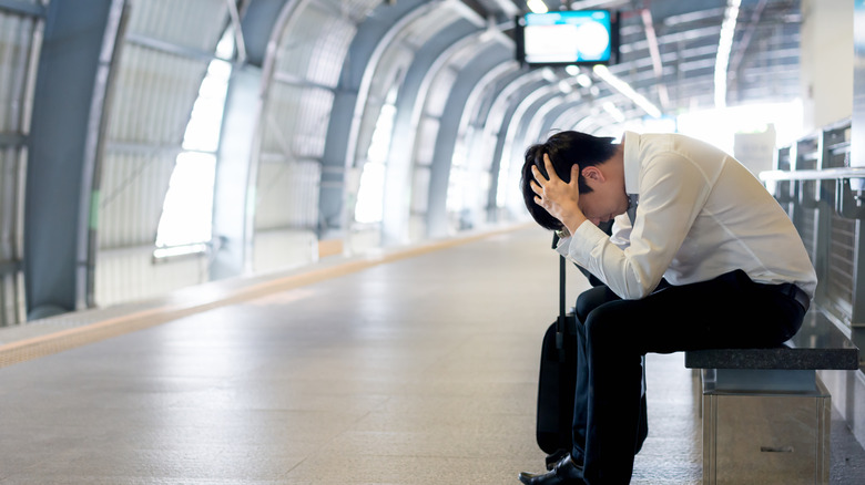 A sad passenger in an empty terminal.