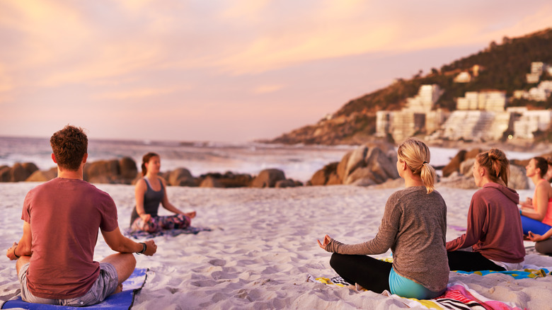 group yoga on beach