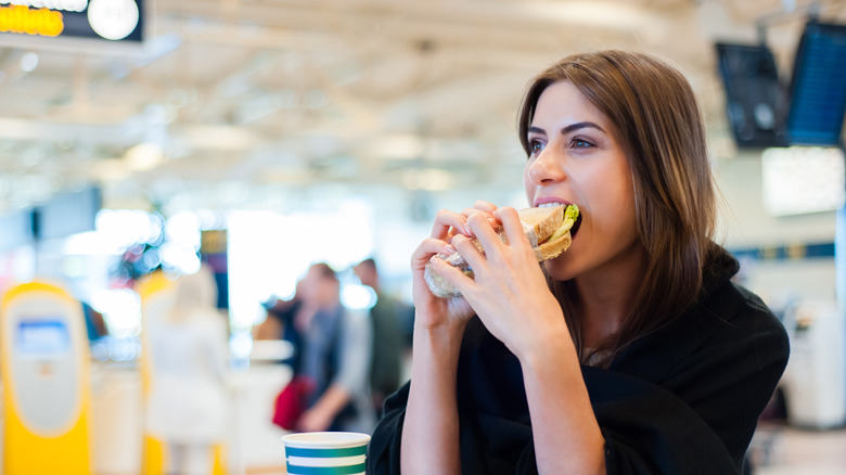 Eating sandwich at airport