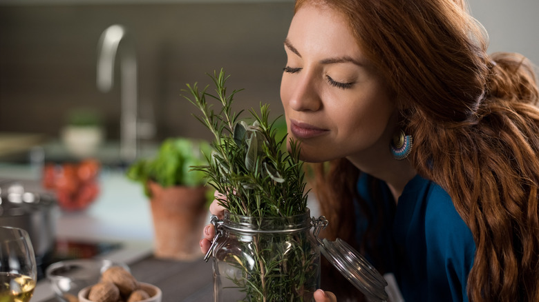 person smelling herbs