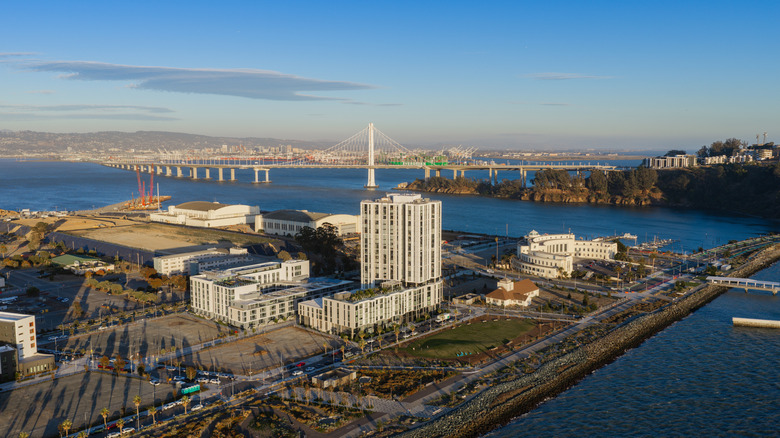 An aerial view of San Francisco's Treasure Island with the Bay Bridge behind