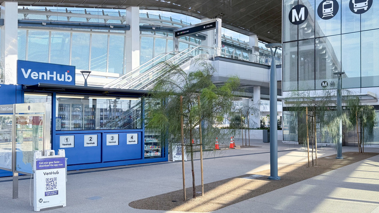 A view of the LAX/Metro Transit Center with a VenHub store and escalators.