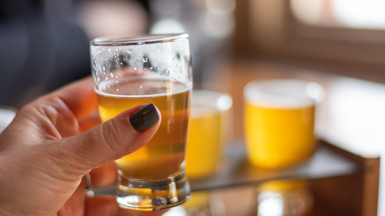 close up of a woman sampling beer