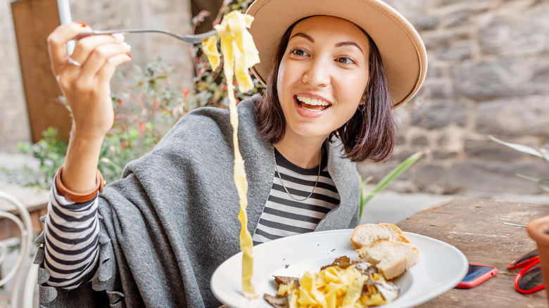 Woman eating pasta