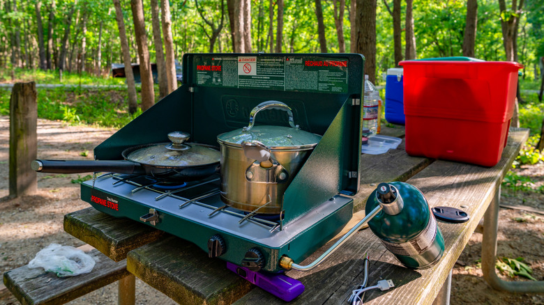 camp stove in use in the woods