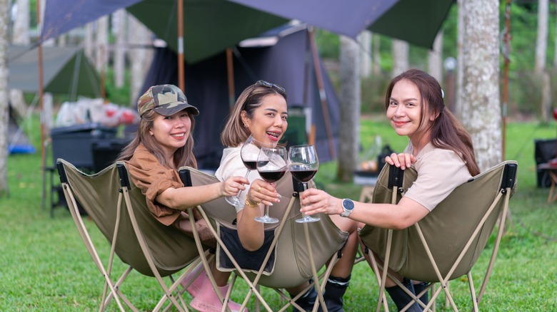 women relaxing in camp chairs
