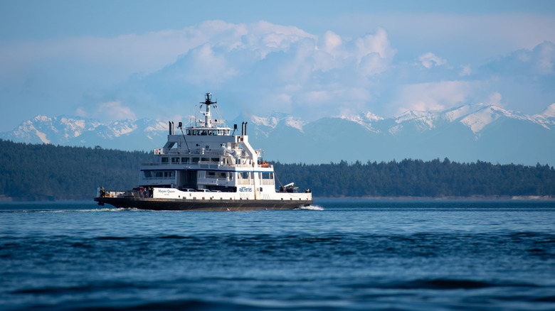 a BC ferry sailing between islands with mountains behind