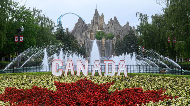 Wonder Mountain and a Canada sign with roller coaster in the background at Canada's Wonderland
