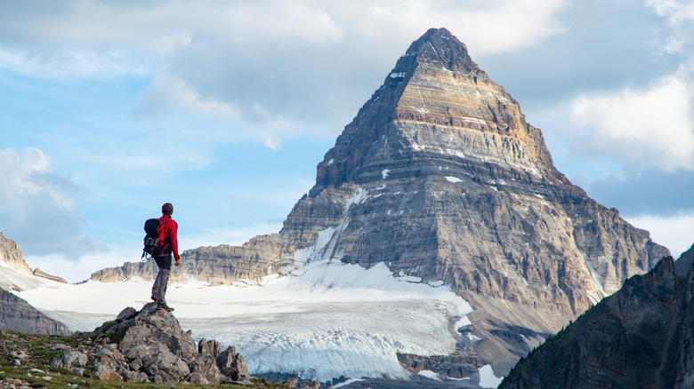 A hiker admires Mount Assiniboine