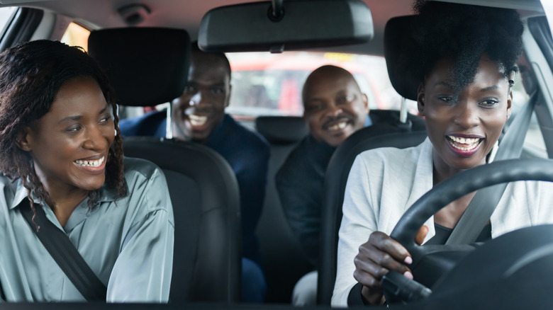 Three people in car driving 