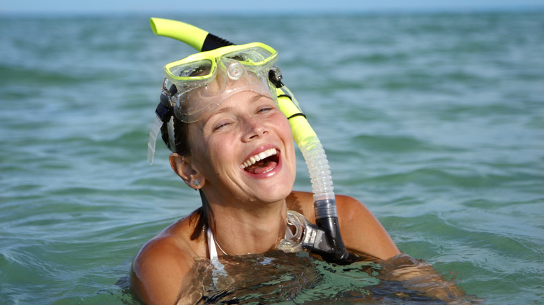 Joyful woman snorkeling