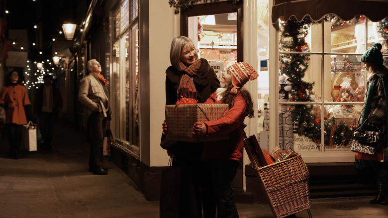 Grandmother and granddaughter carrying gifts