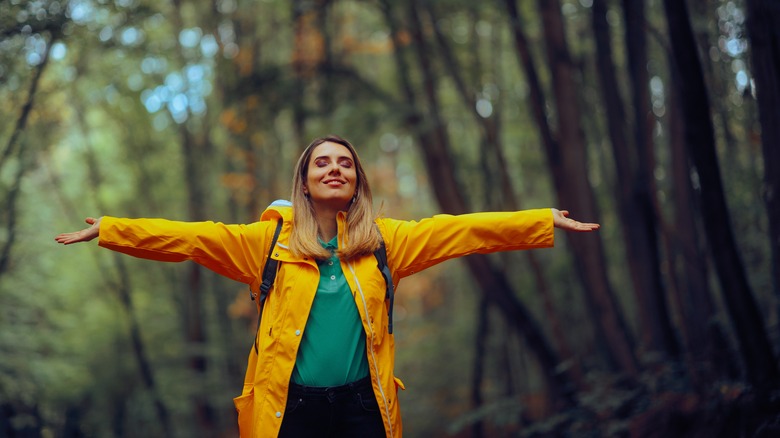 Woman in a yellow jacket enjoying nature
