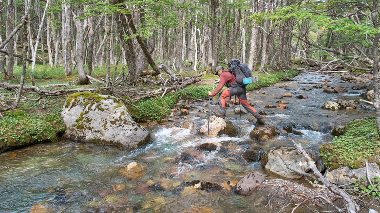hiker crossing a river