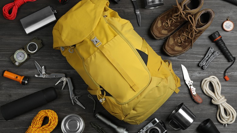 A backpack lies with other outdoor equipment
