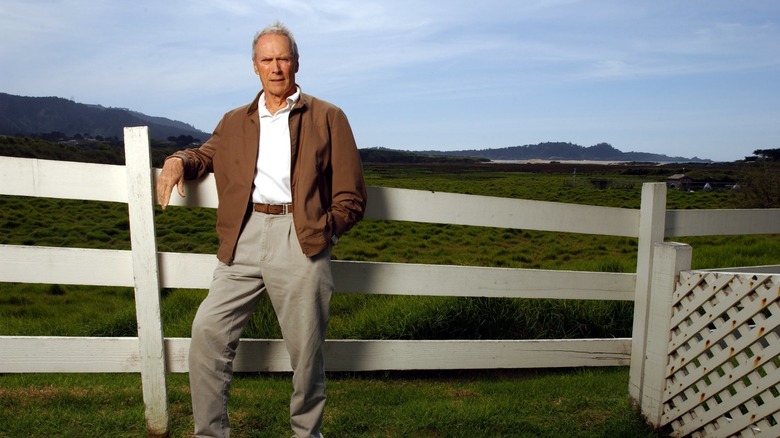 Clint Eastwood posing against the Mission Ranch fence.