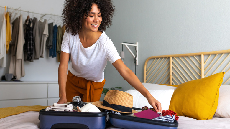 woman packing suitcase