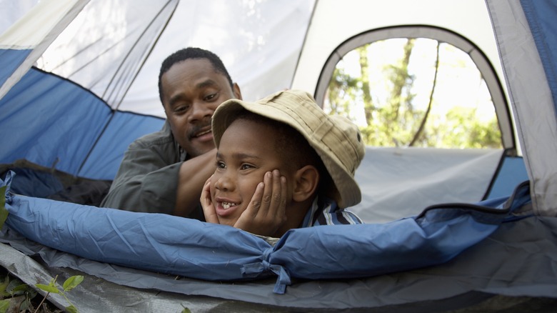 Father and son in tent