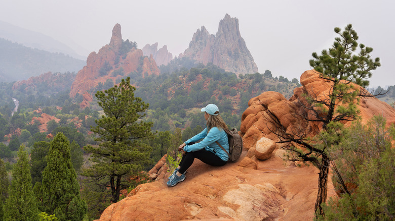 Woman hiker relaxing on hiking trip in the mountain in Garden of the Gods, Colorado Springs, Colorado, USA.