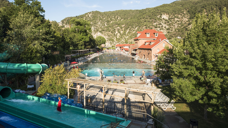 Glenwood Springs, people in public hot springs pool with water slide