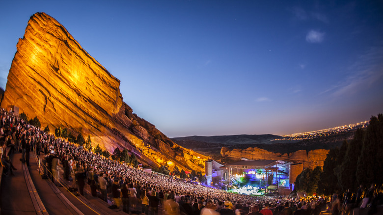 A crowd watches a band play at Red Rocks Amphitheater