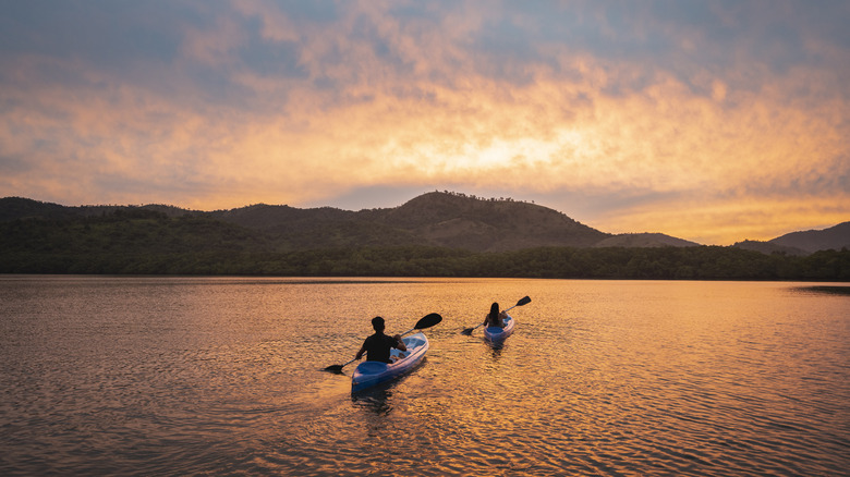 Kayakers on a lake at sunset