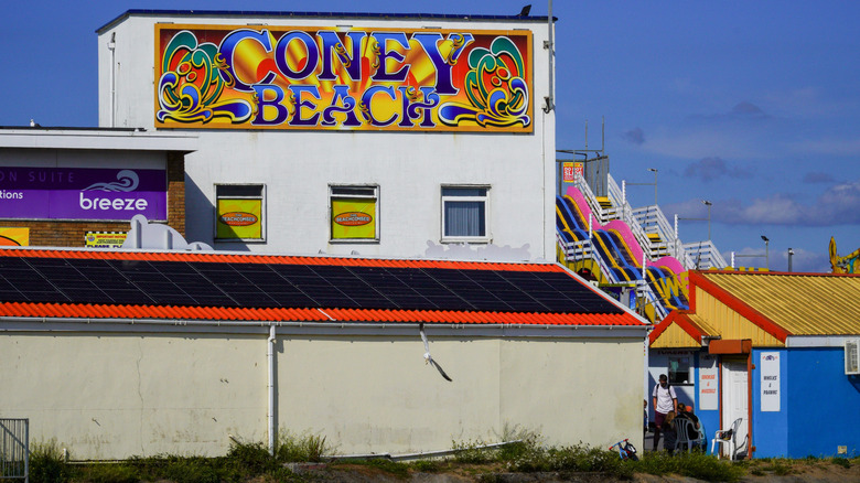 Side view of a building and roller coaster at the park