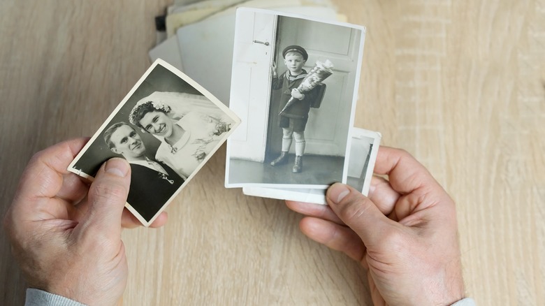 Man holding vintage photographs