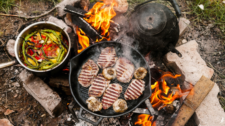 Food cooking on a campfire.