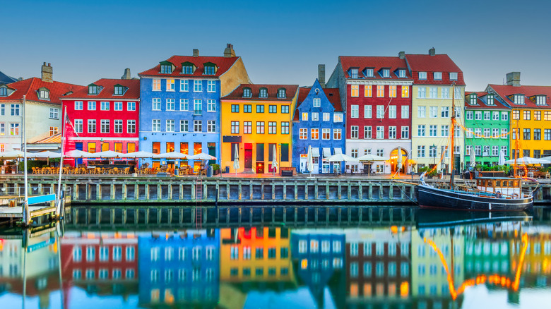Nyhavn waterfront reflected in the water, in Copenhagen, Denmark
