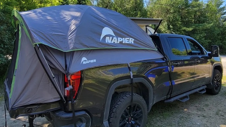 tent attached to back of black truck