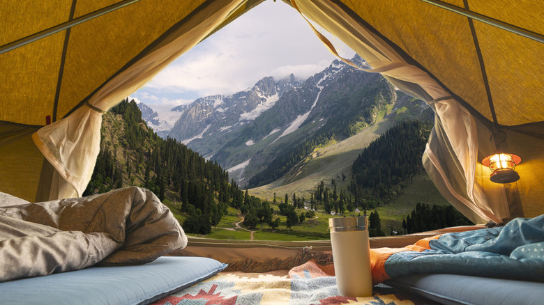 view of mountains from tent's open door