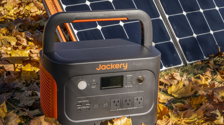 Jackery battery station with solar panels in fall-themed background