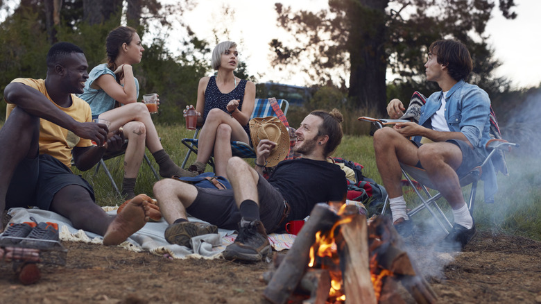 Group of friends hanging around a campfire